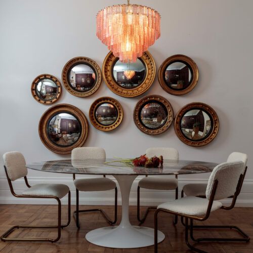 pink chandelier over a tulip dining table
