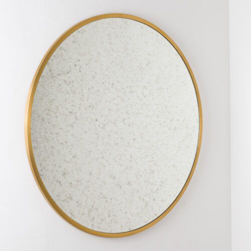 round brass mirror with aged glass