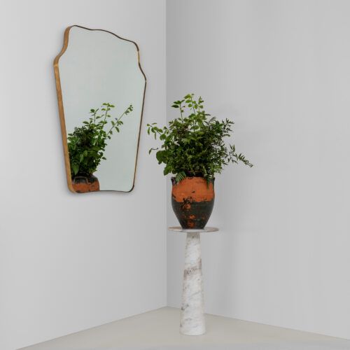 white marble display table with Italian mid-century inspired mirror