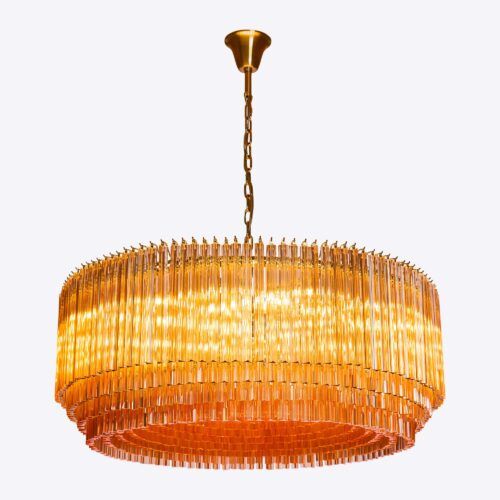 Grande Amber Amaro - large amber drum triedri chandelier in mid-century Murano glass style hanging over a red square marble coffee table