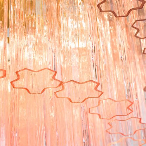 Treviso mid-century inspired tiered glass chandelier in clear smoked quartz or pink glass