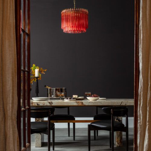pink small chandelier in mid-century style seen with Patagonia quartzite dining table and silver Champagne cooler ice bucket
