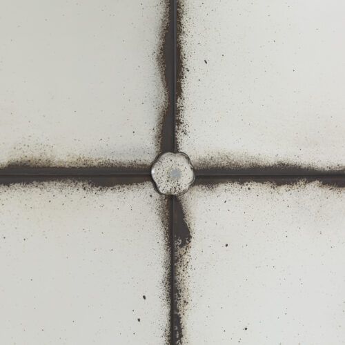 Chateaux rectangular bistro mirror with aged glass and decorative rivets
